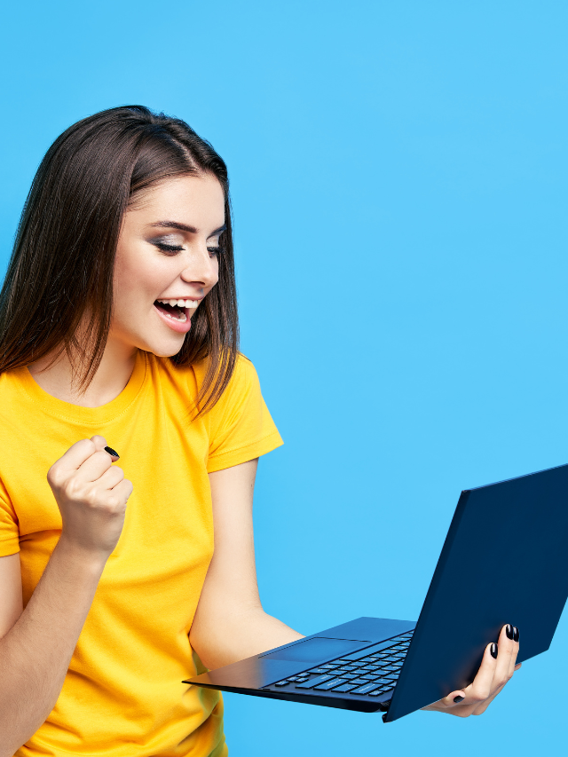 Excited Student Looking at Laptop